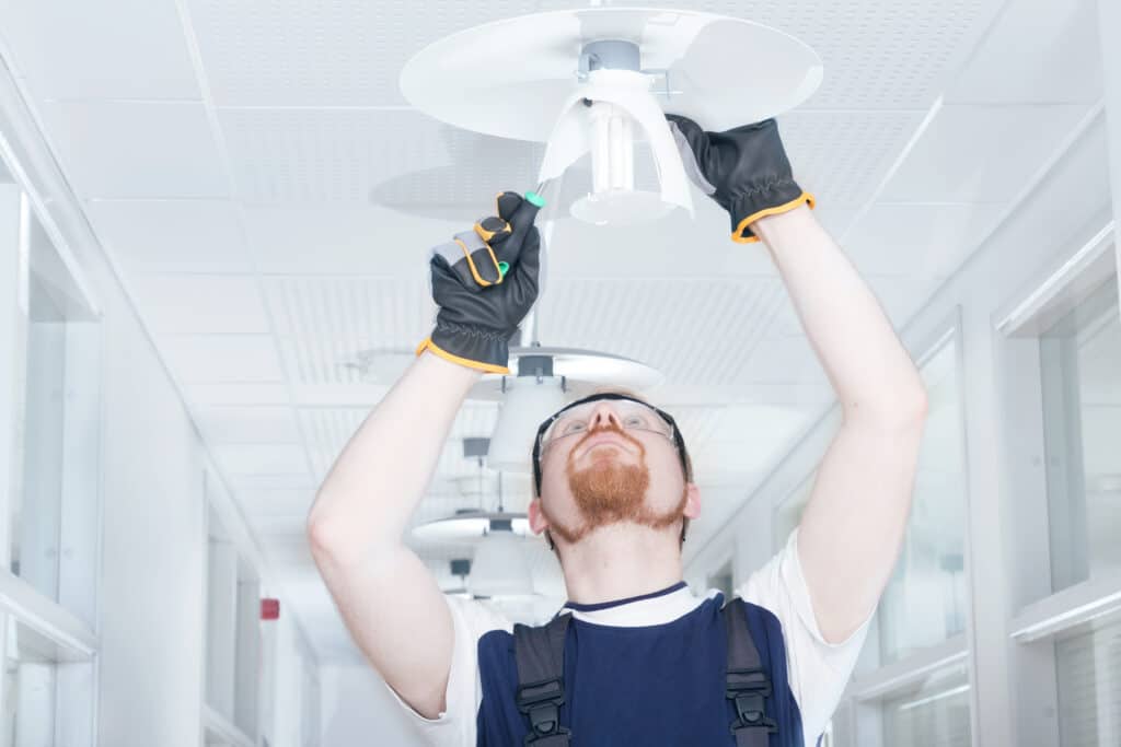 Brassell electrician fixing commercial office light