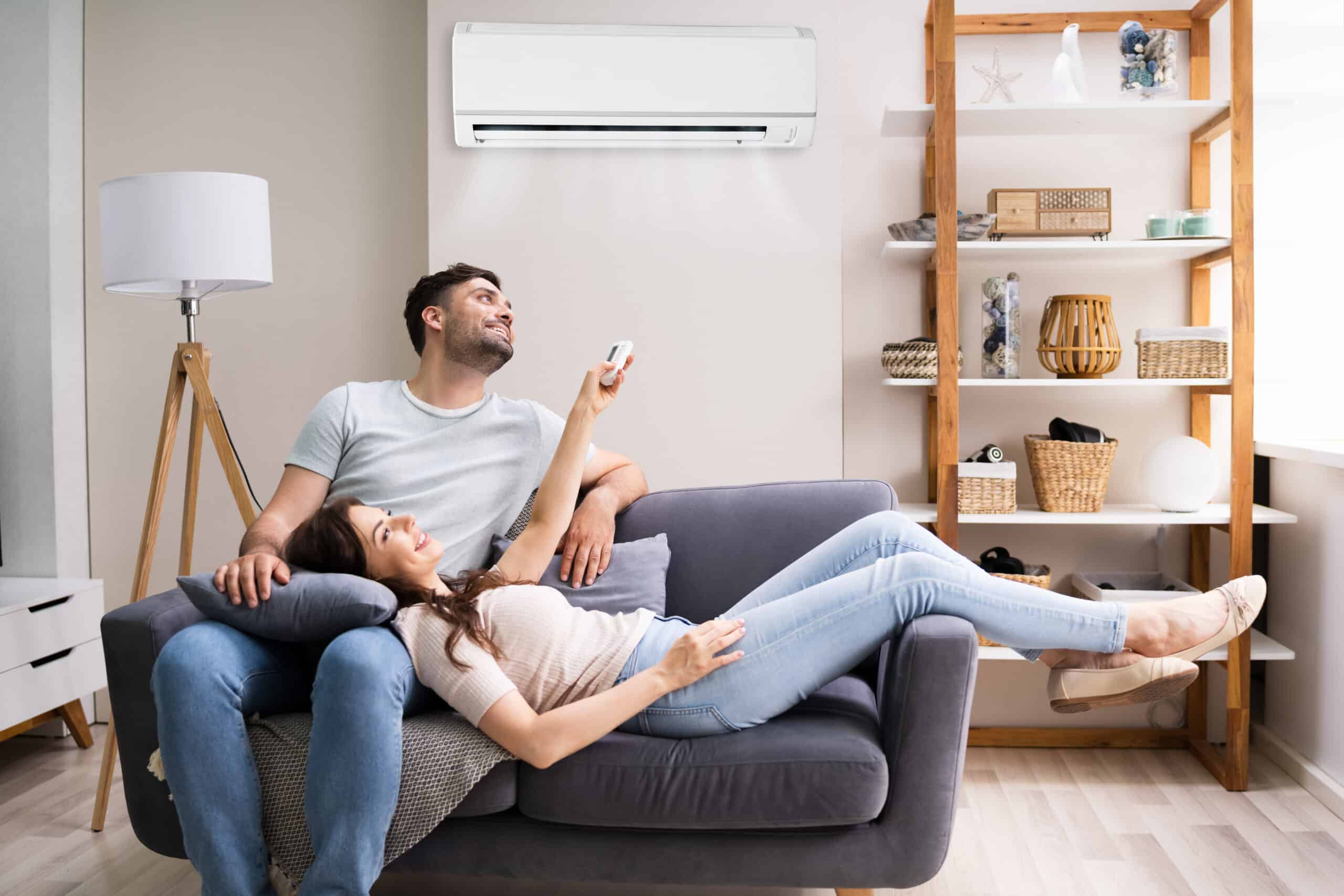 Happy,Woman,Holding,Air,Conditioner,Remote,Control